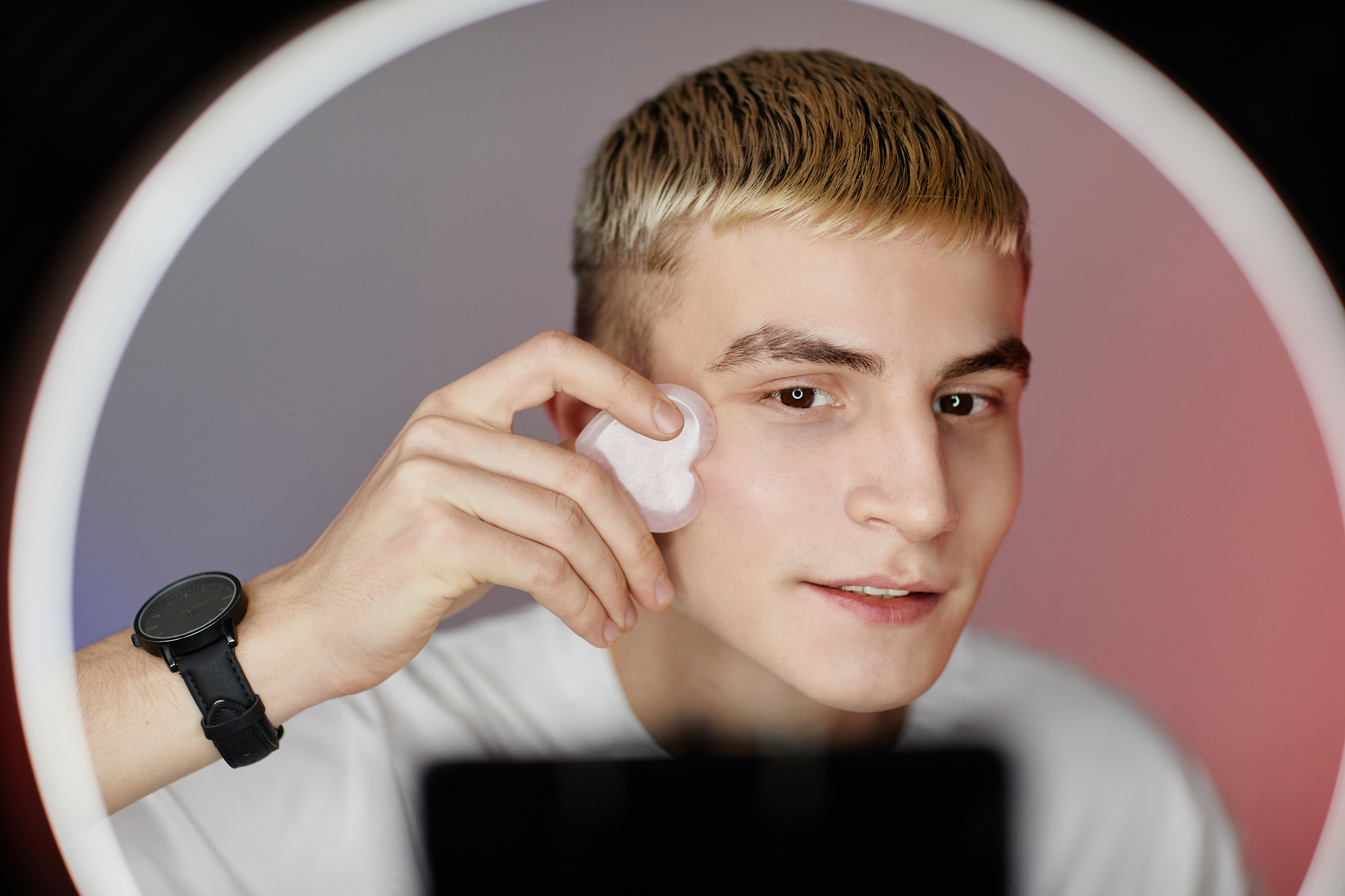 Young Man Filming Skincare Tutorial